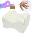 Memory foam knee pillow resting between a side sleeper's legs