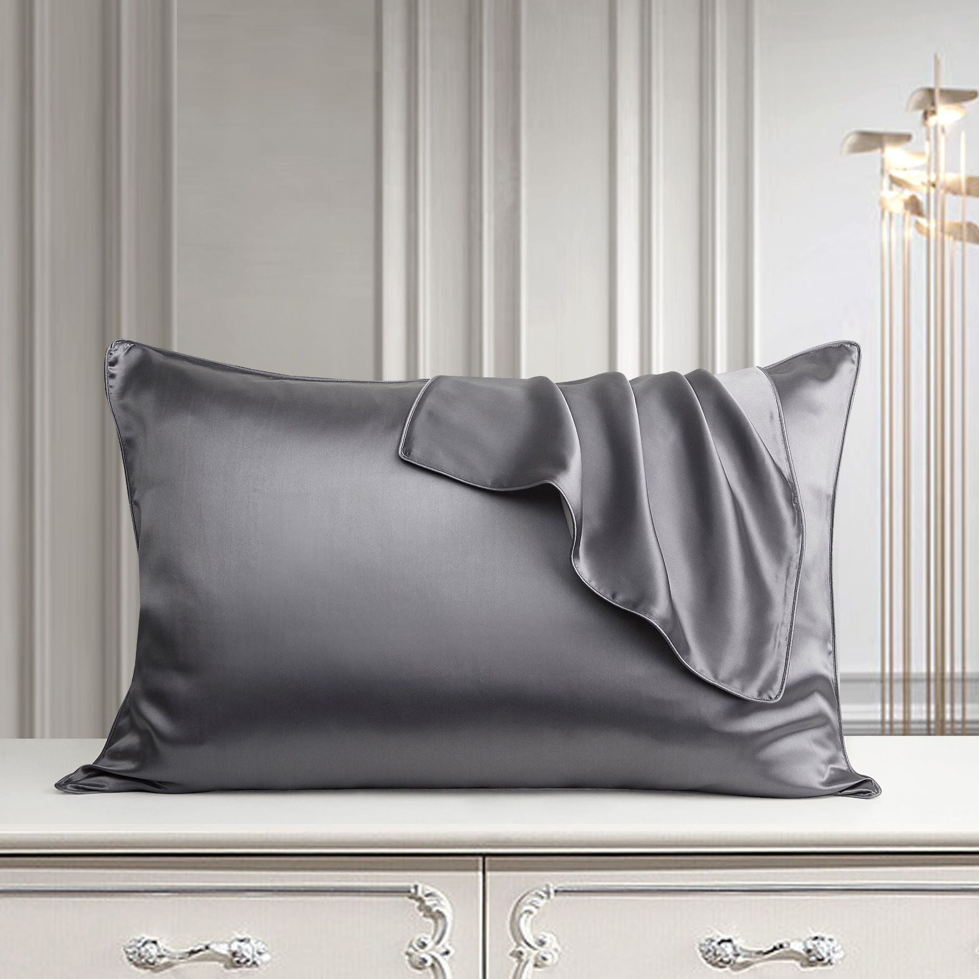 Metal grey mulberry silk pillowcase on a bed